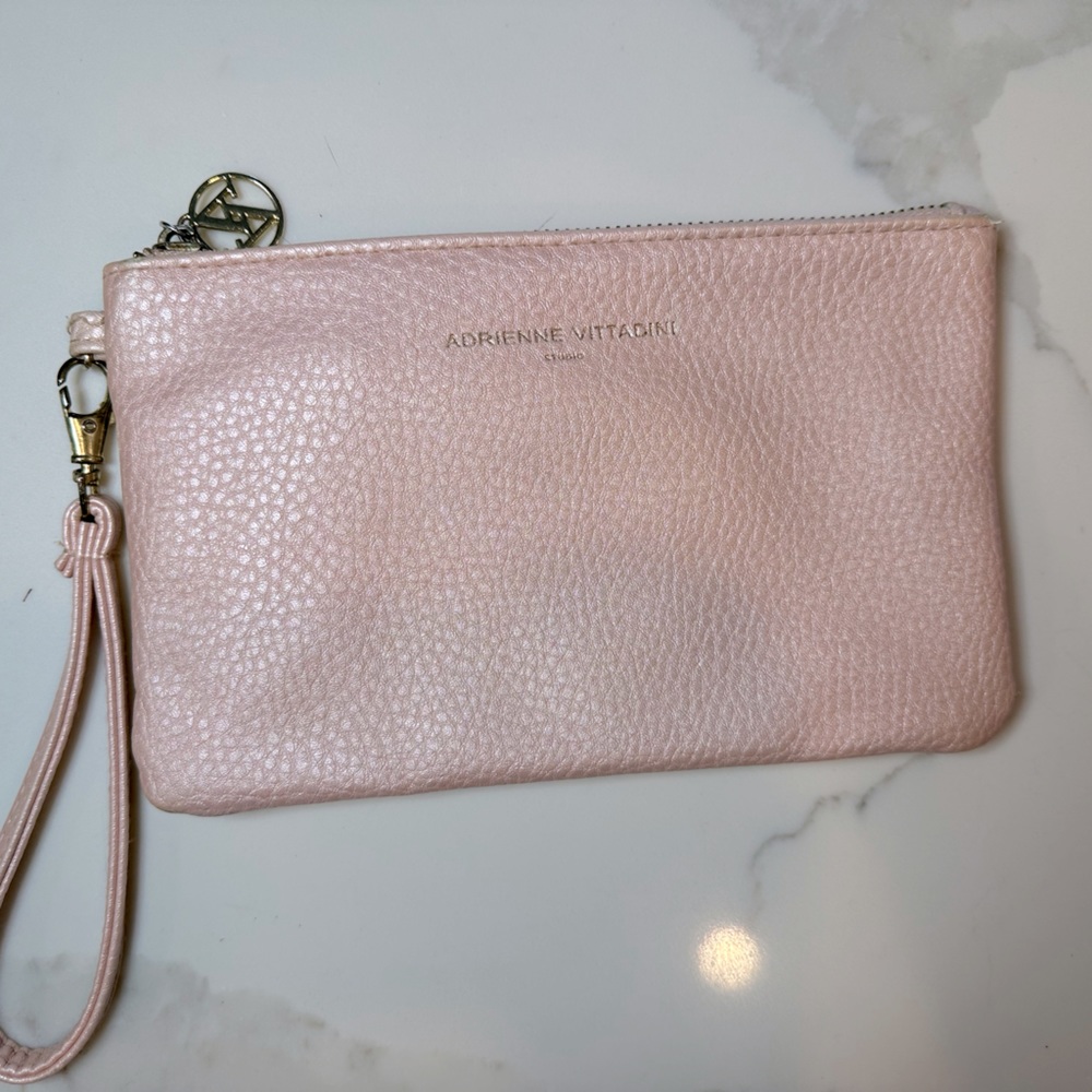 Adrienne Vittadini pink wristlet bag with built-in phone usb charger.
